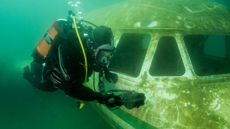 diver inspects plane wreckage